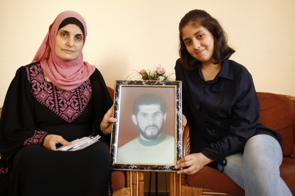 Saadia Hourani and her daughter Lin hold up a photo of Imad Saftawi