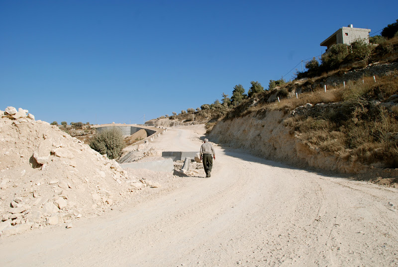 Abu Nidal walking towards the tunnel that connects him to his parents and grandmothers' grave site