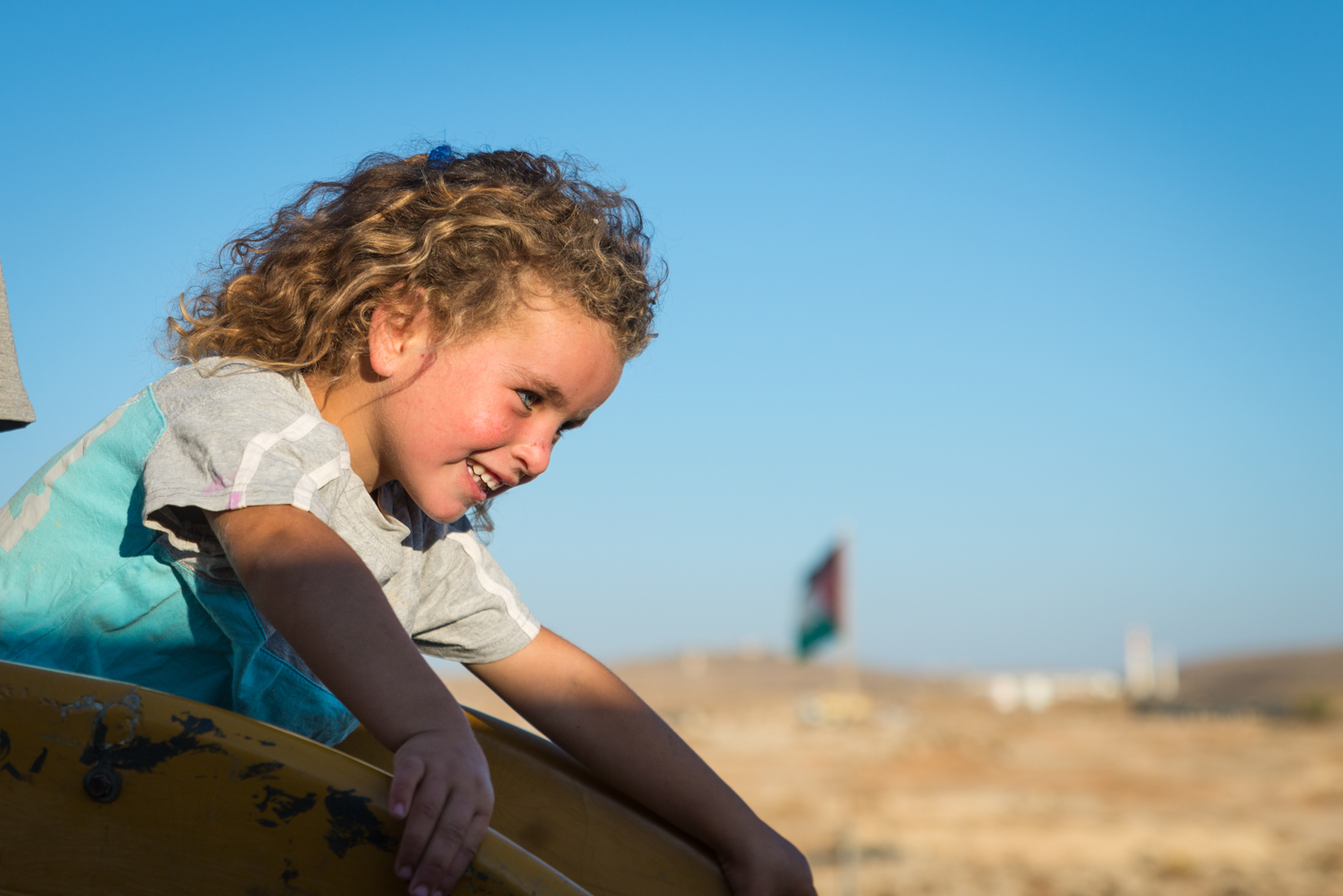 A Palestinian girl plays on a slide in Susiya, oblivious to the fact that it may soon be demolished along with the rest of the village.