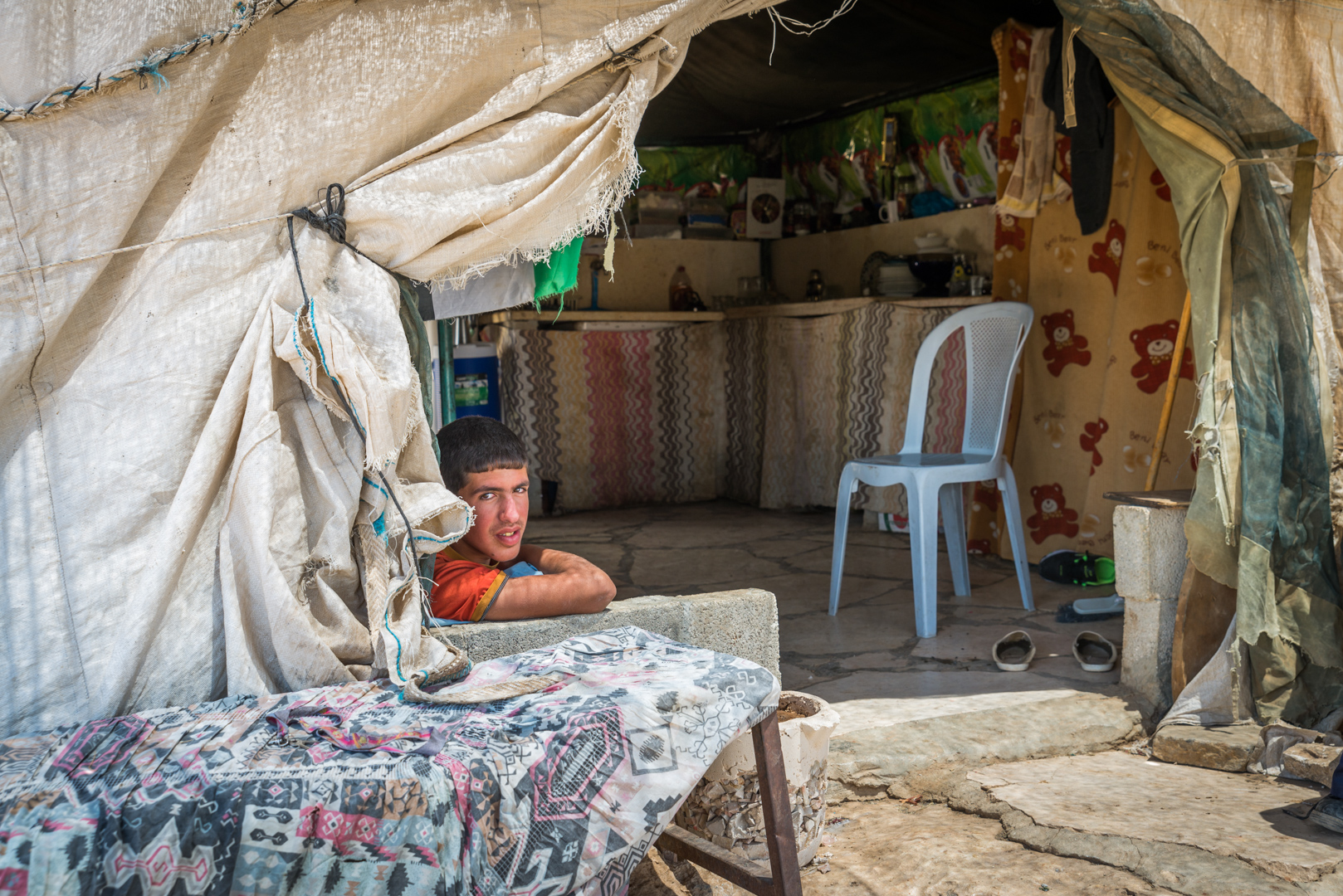 A young Palestinian man sits inside his family's home in Susiya. It is one of the structures due to be demolished by the Israeli army.