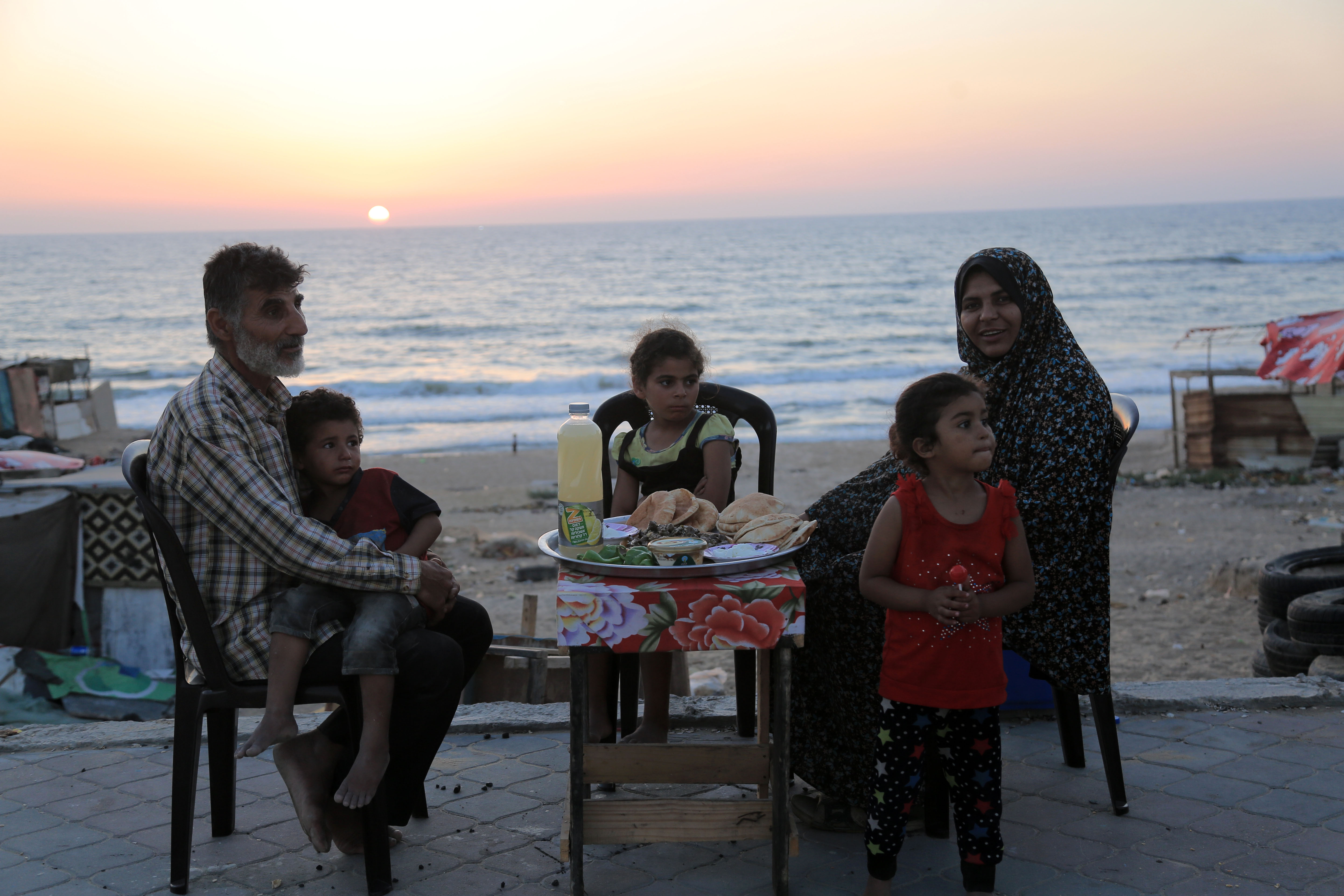The al-Lahham family notices passersby hurry home before breaking the day’s fast and praying al-Maghrib, the fourth of the five daily prayers in Islam. 