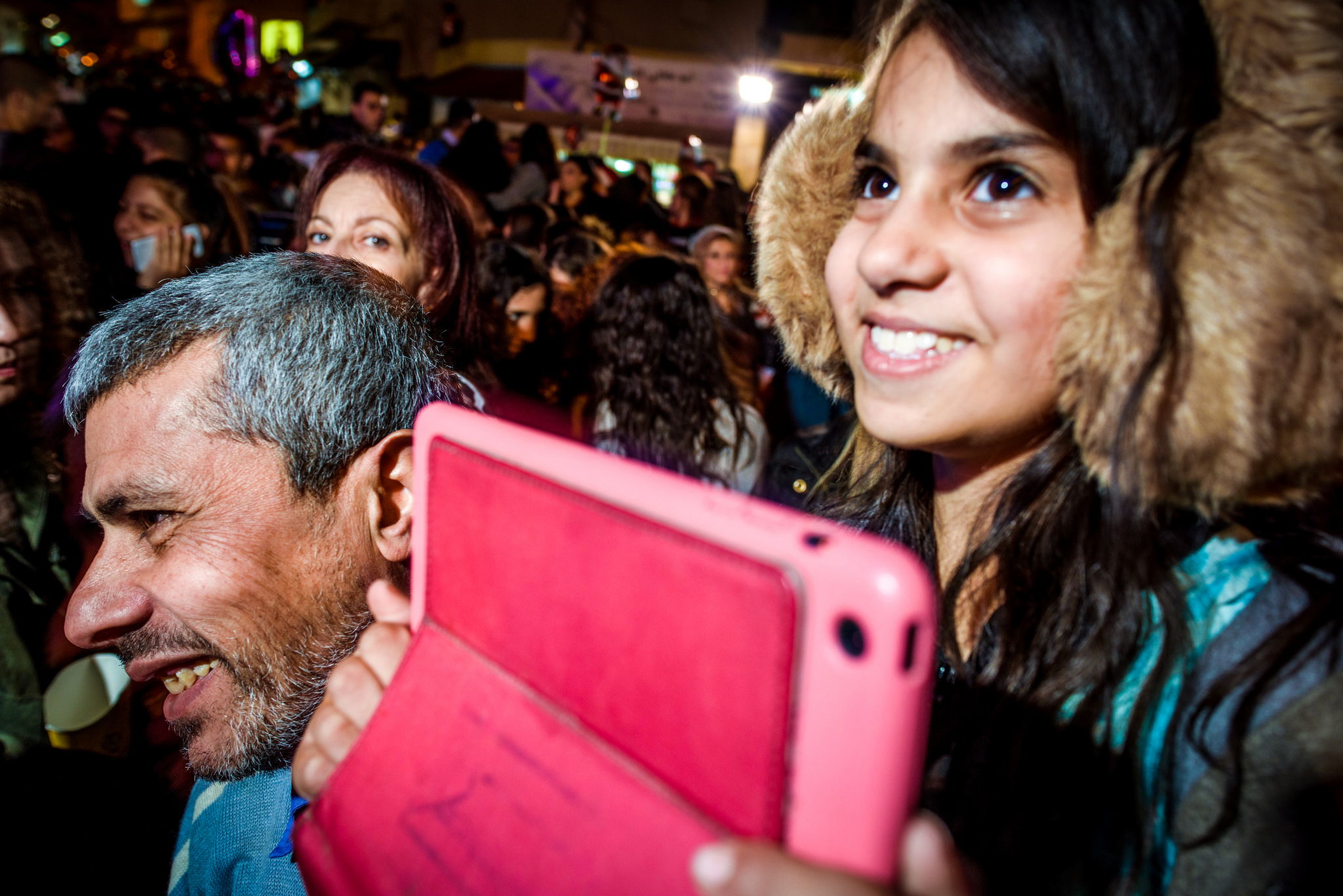 Members of the Mahajneh family watch a variety of performances at the Christmas Tree Lighting Celebration in Nazareth.