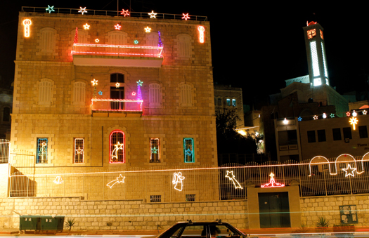 A building in Bethlehem adorned with Christmas decorations. (PHOTO: Firas Mukarker)