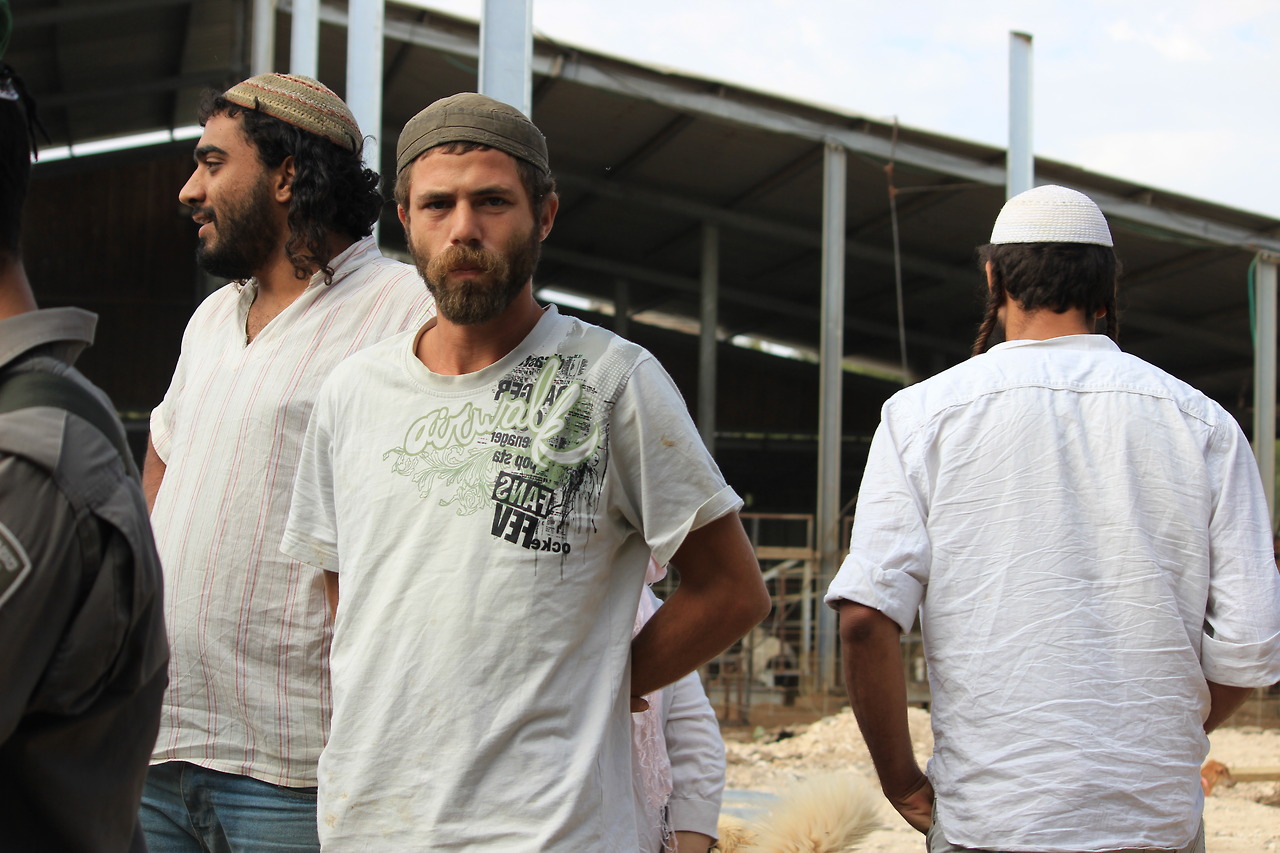 Extremist settlers from Havat Maon gather to block peace activists from inspecting new construction in the outpost.